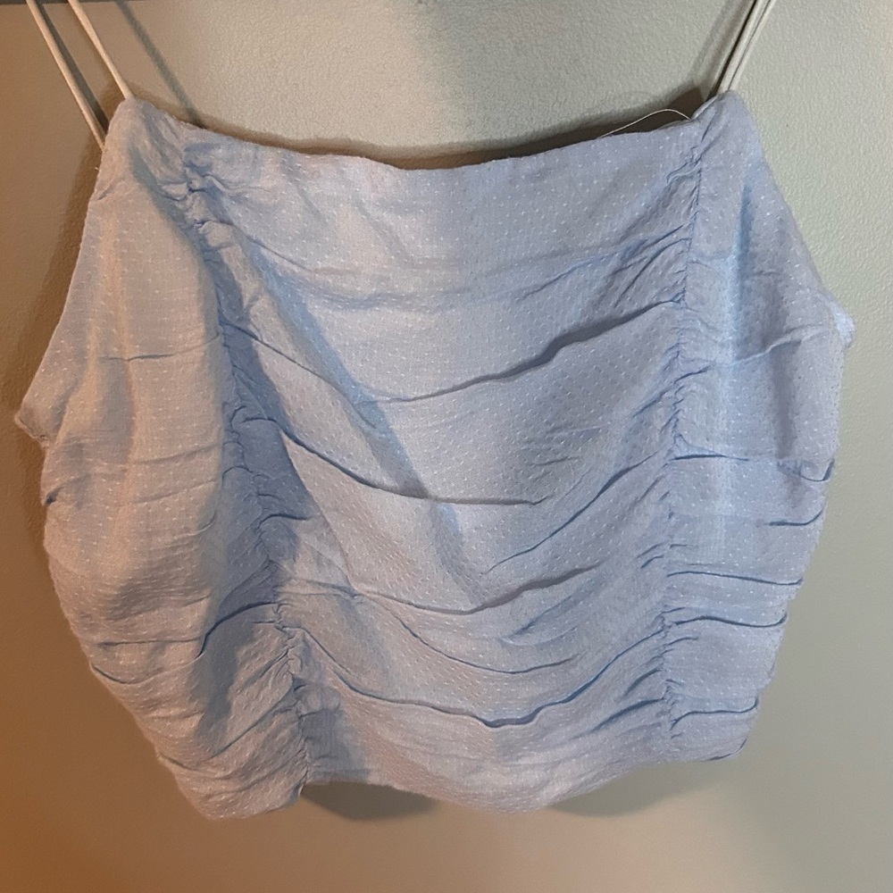 Super cute, light blue tank top. Size xs never worn and in fantastic condition.